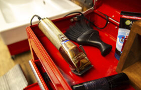 Close-up of barber tools in a red drawer