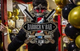 Entrance to Barber N' Bar decorated with black and gold balloons